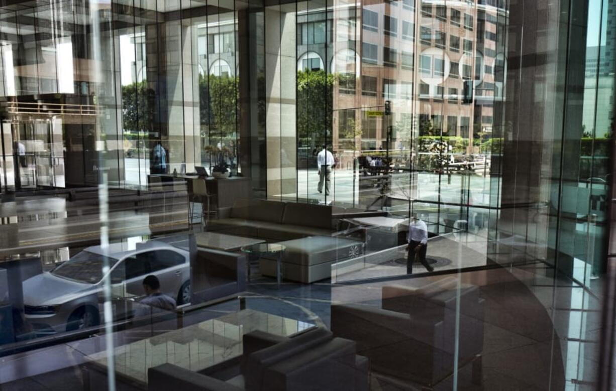 FILE - In this Aug. 27, 2018, file photo downtown Los Angeles buildings and officer workers are reflected in the front windows by a bank. When applying for a personal loan, some lenders may ask you for information that isn&#039;t on your credit report. In some cases, information like where you live, where you went to school and your major are taken into account.