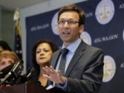 FILE - In this Aug. 26, 2019, file photo, Washington Attorney General Bob Ferguson speaks at a news conference in Seattle. Washington state sued Johnson &amp; Johnson on Thursday, Jan. 2, 2020, claiming the company was negligent when it used deceptive marketing to say the drugs were effective for treating pain and were unlikely to cause addiction. The lawsuit filed Thursday says the company that supplies raw materials used to make opiates drove the pharmaceutical industry to recklessly expand the production of the drugs. (AP Photo/Ted S.