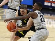 Oregon guard Payton Pritchard, left, fights for control of the ball with Colorado guard McKinley Wright IV in the first half of an NCAA college basketball game Thursday, Jan. 2, 2020, in Boulder, Colo.