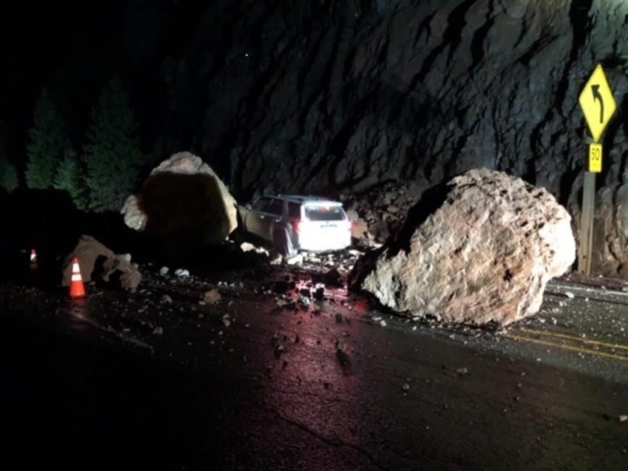 This photo provided by The Oregon Department of Transportation shows two enormous boulders that fell onto Highway 62, almost crushing a car outside of Prospect, Ore. on Tuesday, Jan. 28, 2020. The unrelenting rain around Oregon this week is having an impact, with multiple roads and highways closed around the state due to flooding and rockslides. Officials in Yamhill County said a driver was rescued from a flooded vehicle Tuesday morning near Amity after the car stalled in about a foot of water and some local roads in Washington County were closed due to flooding.