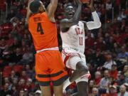 Utah guard Both Gach (11) goes to the basket as Oregon State forward Alfred Hollins (4) defends in the second half during an NCAA college basketball game Thursday, Jan. 2, 2020, in Salt Lake City.