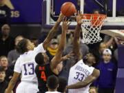 Oregon State forward Alfred Hollins (4) has a shot blocked by Washington forward Isaiah Stewart (33) and forward Hameir Wright (13) during the first half of an NCAA college basketball game Thursday, Jan. 16, 2020, in Seattle. (AP Photo/Ted S.