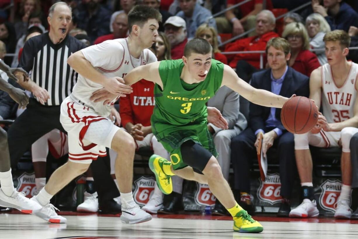 Oregon guard Payton Pritchard (3) drives around Utah guard Rylan Jones, left, in the second half during an NCAA college basketball game Saturday, Jan. 4, 2020, in Salt Lake City.