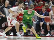 Oregon guard Payton Pritchard (3) drives around Utah guard Rylan Jones, left, in the second half during an NCAA college basketball game Saturday, Jan. 4, 2020, in Salt Lake City.