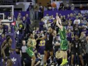 Oregon guard Payton Pritchard, right, shoots the game-winning 3-point basket as Washington guard Jamal Bey (5) tries for the block during overtime in an NCAA college basketball game, Saturday, Jan. 18, 2020, in Seattle. Oregon won 64-61 in overtime. (AP Photo/Ted S.