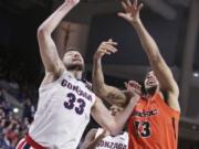 Gonzaga forward Killian Tillie (33) and Pacific forward Jeremiah Bailey (13) go after a rebound during the first half of an NCAA college basketball game in Spokane, Wash., Saturday, Jan. 25, 2020.