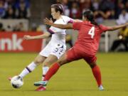 U.S. forward Megan Rapinoe (15) moves the ball under pressure from Panama defender Hilary Jaen (4) during the first half of a CONCACAF women&#039;s Olympic qualifying soccer match Friday, Jan. 31, 2020, in Houston.