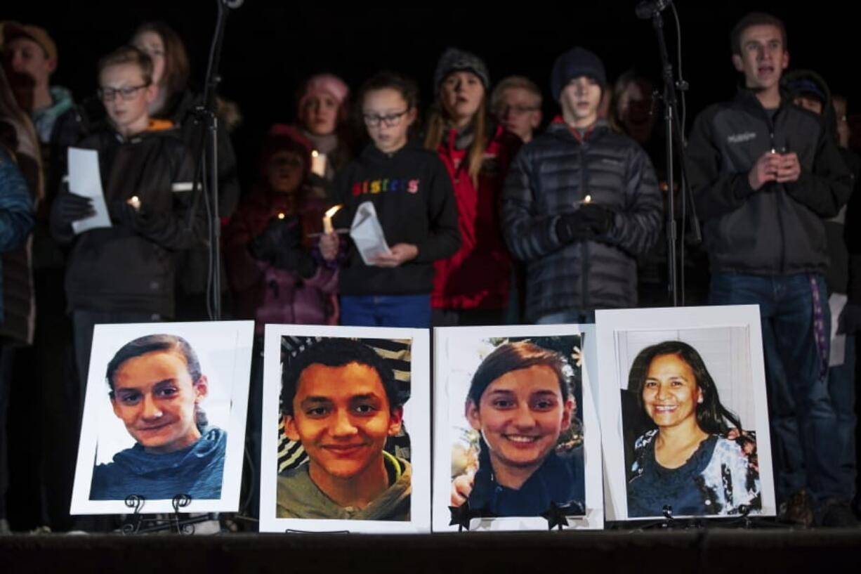 Photographs of Consuelo Alejandra Haynie, 52, right, and three of her children, 12-year-old Maylan, 14-year-old Mathew, and 15-year-old Alexis Haynie, left to right, are displayed at a candlelight vigil for the Haynie family at City Park in Grantsville, Utah, Monday, Jan. 20, 2020. Police say four members of the Haynie family were killed and one injured after being shot by a teenage family member on Jan. 17.