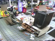 Michael Veatch can be seen in security video pointing a gun at convenience store employees in St. Helens, Ore., the night he was killed by police.