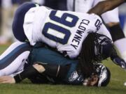 Philadelphia Eagles&#039; Carson Wentz (11) is hit by Seattle Seahawks&#039; Jadeveon Clowney (90) during the first half of an NFL wild-card playoff football game, Sunday, Jan. 5, 2020, in Philadelphia.