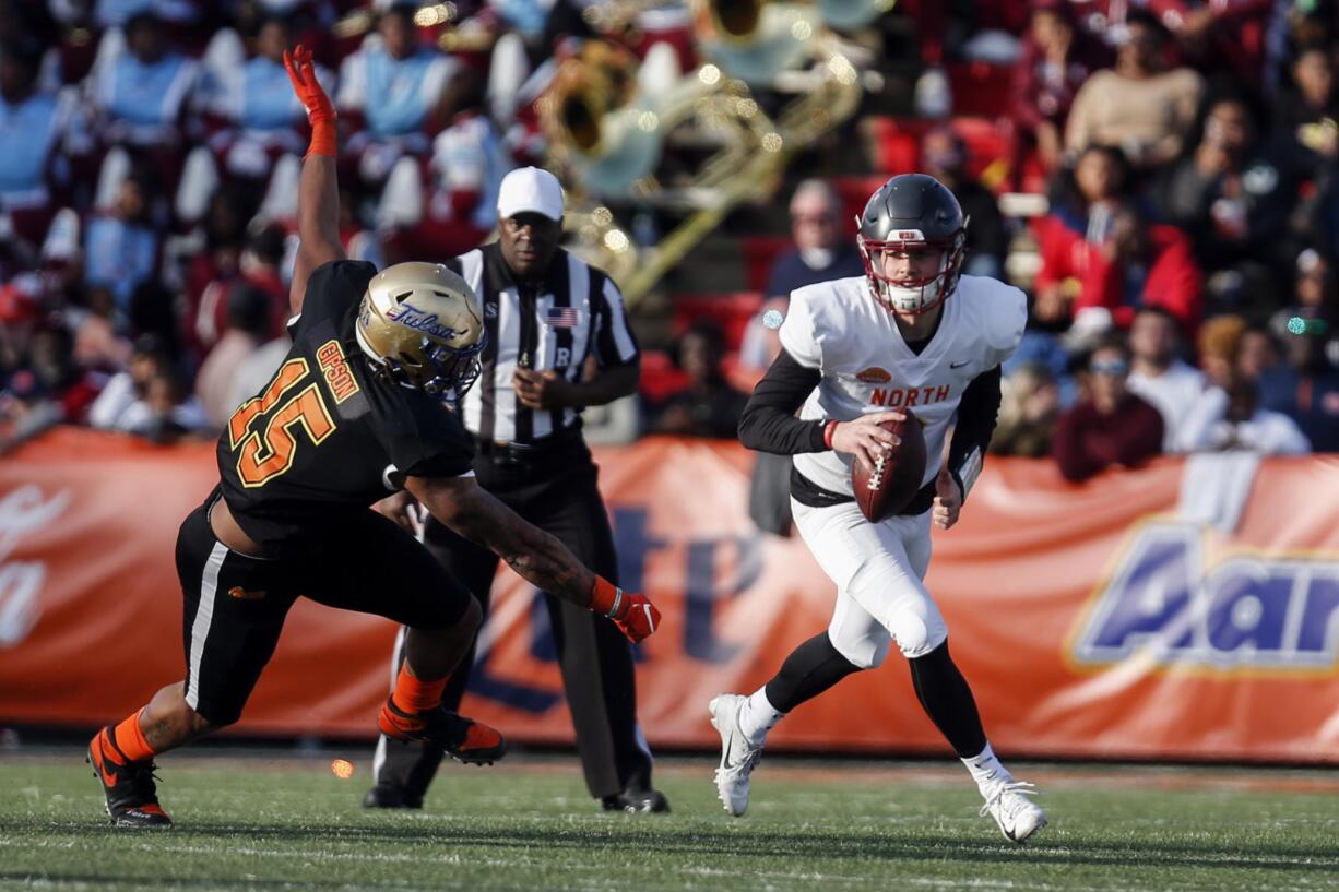 North quarterback Anthony Gordon of Washington State (3) scrambles away from South defensive end Trevis Gipson of Tulsa (15) during the second half of the Senior Bowl college football game Saturday, Jan. 25, 2020, in Mobile, Ala.