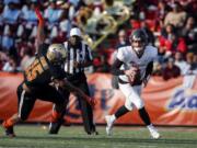 North quarterback Anthony Gordon of Washington State (3) scrambles away from South defensive end Trevis Gipson of Tulsa (15) during the second half of the Senior Bowl college football game Saturday, Jan. 25, 2020, in Mobile, Ala.