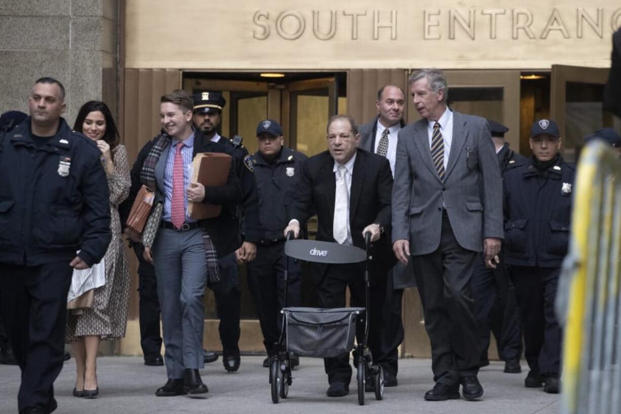 Harvey Weinstein uses a walker as he leaves a Manhattan courthouse after a day in his trial on rape and sexual assault charges, Thursday, Jan. 23, 2020, in New York.