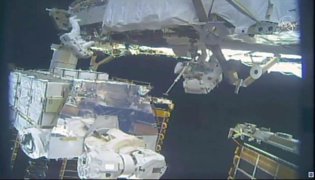 In this image take from NASA video, astronauts Jessica Meir, right, and Christina Koch install batteries for the International Space Station&#039;s solar power grid during a space walk Monday, Jan. 20, 2020.