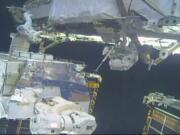 In this image take from NASA video, astronauts Jessica Meir, right, and Christina Koch install batteries for the International Space Station&#039;s solar power grid during a space walk Monday, Jan. 20, 2020.