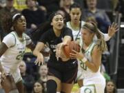 Oregon&#039;s Ruthy Hebard, left, Satou Sabally, rear, and Sabrina Ionescu, right, battle Stanford&#039;s Haley Jones for the ball during Thursday&#039;s game in Eugene, Ore.