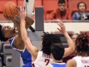 UCLA guard Chris Smith (5) attempts a shot under the basket as Washington State forward CJ Elleby (2) defends in the first half of an NCAA college basketball game, Saturday, Jan. 4, 2020, in Pullman, Wash.