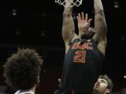 Southern California forward Onyeka Okongwu, center, goes up for a dunk between Washington State forward CJ Elleby, left, and center Volodymyr Markovetskyy during the first half of an NCAA college basketball game in Pullman, Wash., Thursday, Jan. 2, 2020.