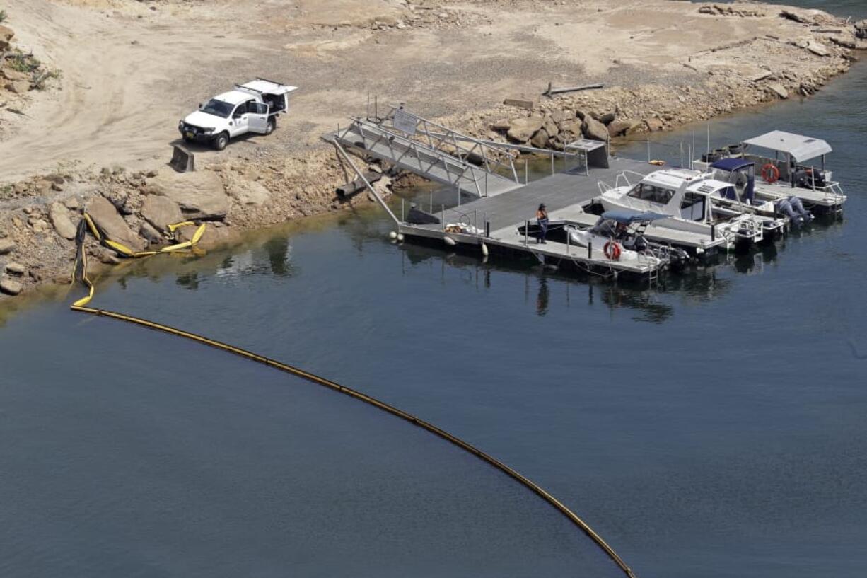 A boom floats across a small bay near the dam wall Wednesday at Warragamba Dam in Warragamba, Australia. Although there have been no major impacts on drinking water yet from the intense wildfires, authorities know from experience that the risks will be elevated for years while the damaged catchment areas, including pine and eucalyptus forests, recover.