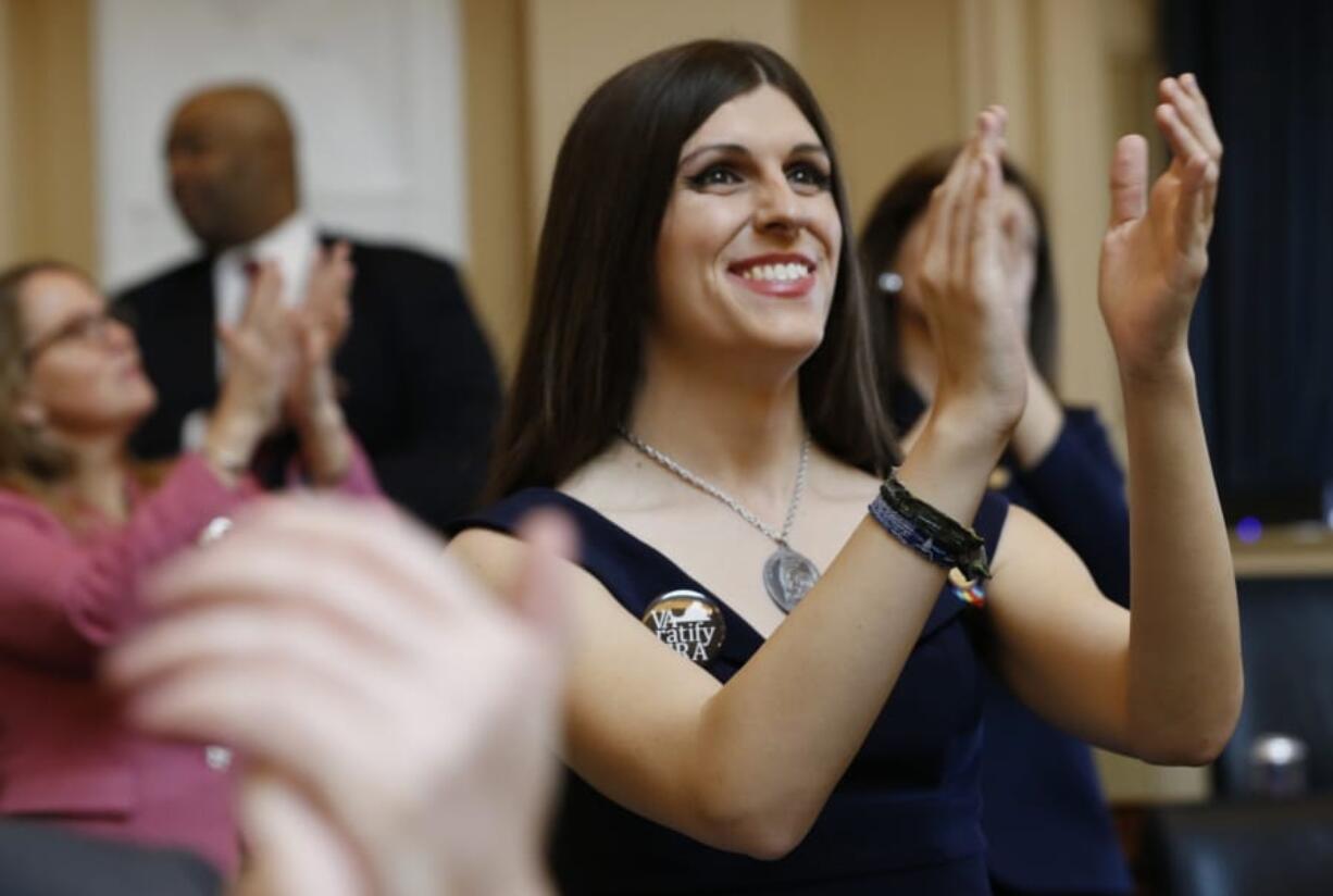 FILE - In this Jan. 9, 2019 file photo, Del. Danica Roem, D-Prince William, right, applauds visitors during opening ceremonies at the start of the 2019 session of the Virginia General Assembly in the House chambers at the Capitol in Richmond, Va.  Supporters of the Equal Rights Amendment are confident Virginia is on the verge of becoming the critical 38th state to ratify the gender equality measure.  The proposed 28th amendment to the U.S.