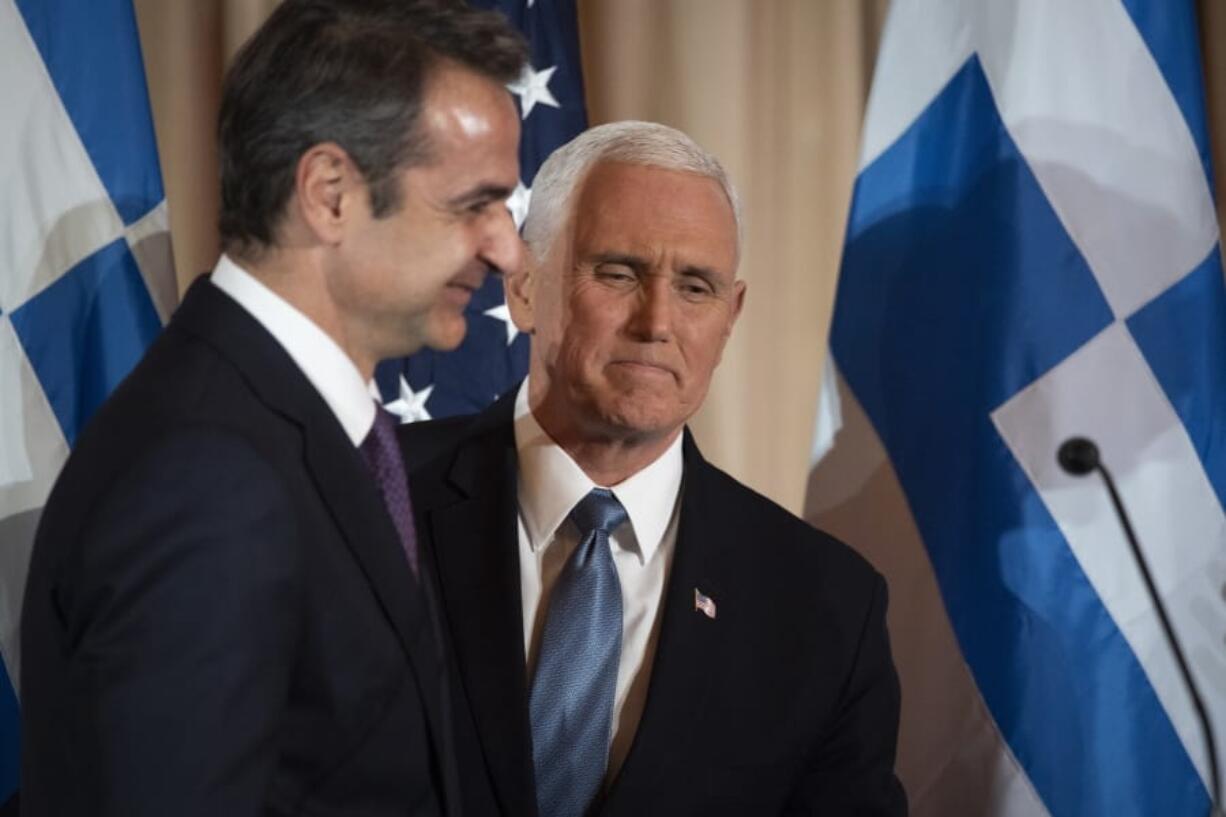 Vice President Mike Pence, right, and Greek Prime Minister Kyriakos Mitsotakis appear at a reception, hosted by Secretary of State Mike Pompeo, at the State Department in Washington, Wednesday, Jan. 8, 2020.