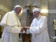 FILE - In this June 28, 2017, file photo, Pope Francis, left, and Pope Benedict XVI, meet each other on the occasion of the elevation of five new cardinals at the Vatican. Retired Pope Benedict XVI has broken his silence to reaffirm the value of priestly celibacy, co-authoring a bombshell book at the precise moment that Pope Francis is weighing whether to allow married men to be ordained to address the Catholic priest shortage.