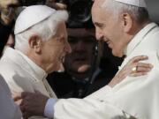 FILE - In this Sept. 28, 2014 file photo, Pope Francis, right, hugs Pope Benedict XVI prior to the start of a meeting with elderly faithful in St. Peter&#039;s Square at the Vatican. Retired Pope Benedict XVI has broken his silence to reaffirm the value of priestly celibacy, co-authoring a bombshell book at the precise moment that Pope Francis is weighing whether to allow married men to be ordained to address the Catholic priest shortage.