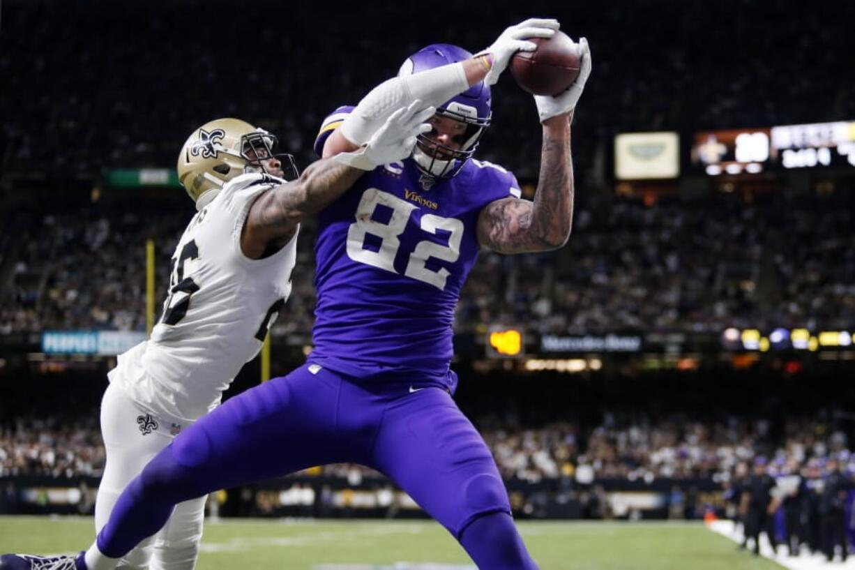 Minnesota Vikings tight end Kyle Rudolph (82) pulls in the game winning touchdown pass over New Orleans Saints cornerback P.J. Williams during overtime of an NFL wild-card playoff football game, Sunday, Jan. 5, 2020, in New Orleans. The Vikings won 26-20.