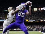 Minnesota Vikings tight end Kyle Rudolph (82) pulls in the game winning touchdown pass over New Orleans Saints cornerback P.J. Williams during overtime of an NFL wild-card playoff football game, Sunday, Jan. 5, 2020, in New Orleans. The Vikings won 26-20.