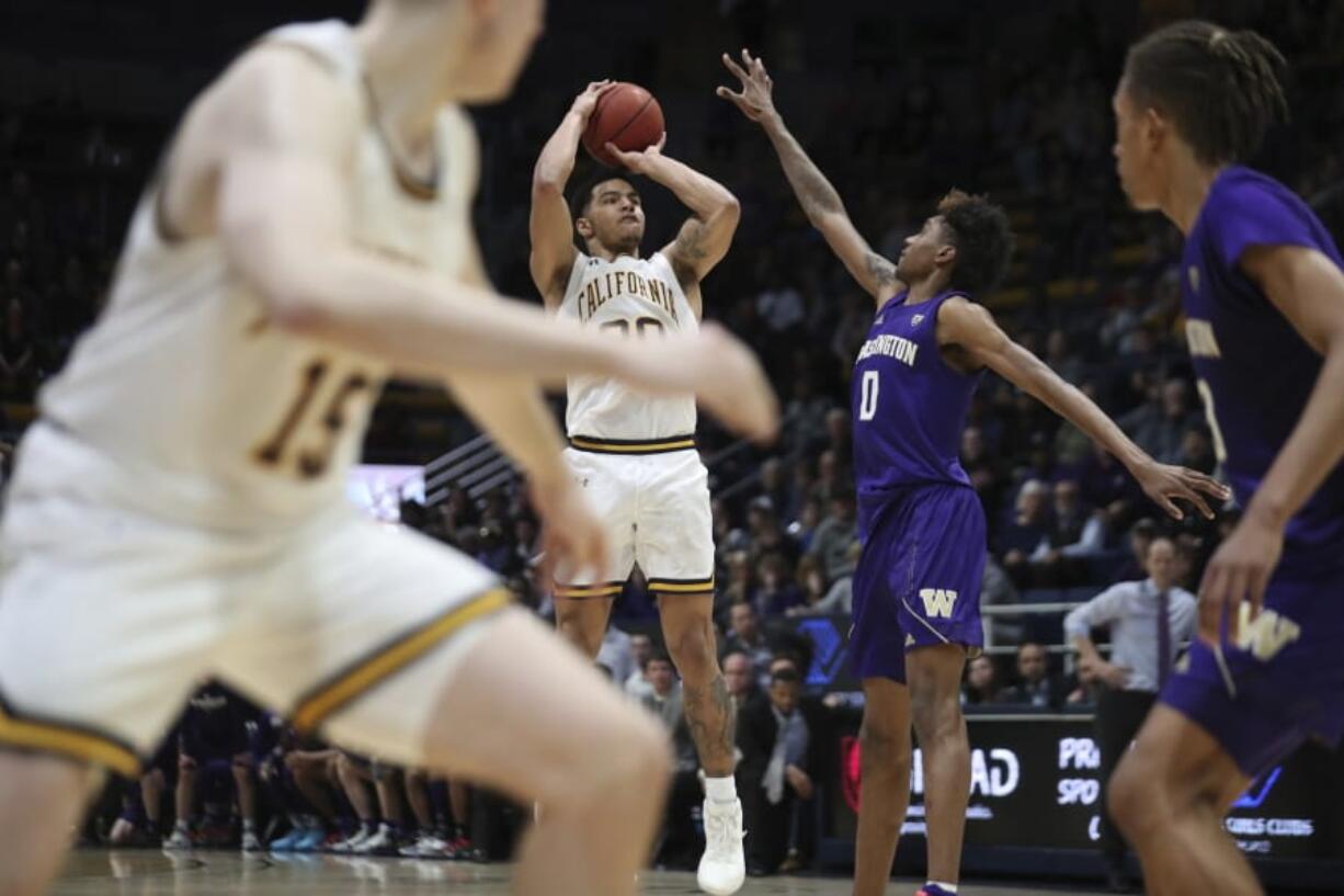 California guard Matt Bradley (20) hits the winning basket in overtime against Washington forward Jaden McDaniels (0) during the second half of an NCAA college basketball game in Berkeley, Calif., Saturday, Jan. 11, 2020.