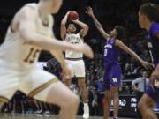 California guard Matt Bradley (20) hits the winning basket in overtime against Washington forward Jaden McDaniels (0) during the second half of an NCAA college basketball game in Berkeley, Calif., Saturday, Jan. 11, 2020.