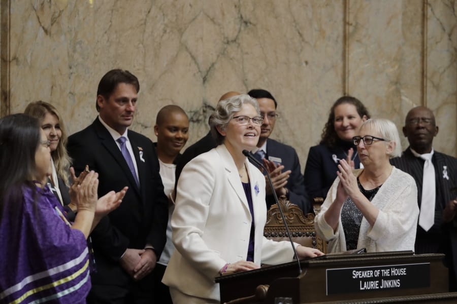 House Speaker Laurie Jinkins, D-Tacoma, center, is applauded as she steps up to speak after being sworn, Monday, Jan. 13, 2020, on the first day of the 2020 session of the Washington legislature at the Capitol in Olympia, Wash. (AP Photo/Ted S.