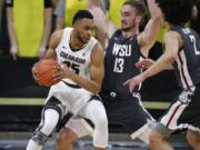 Colorado forward Dallas Walton, left, drives to the rim as Washington State forwards Jeff Pollard, center, and CJ Elleby defend in the first half of an NCAA college basketball game Thursday, Jan. 23, 2020, in Boulder, Colo.