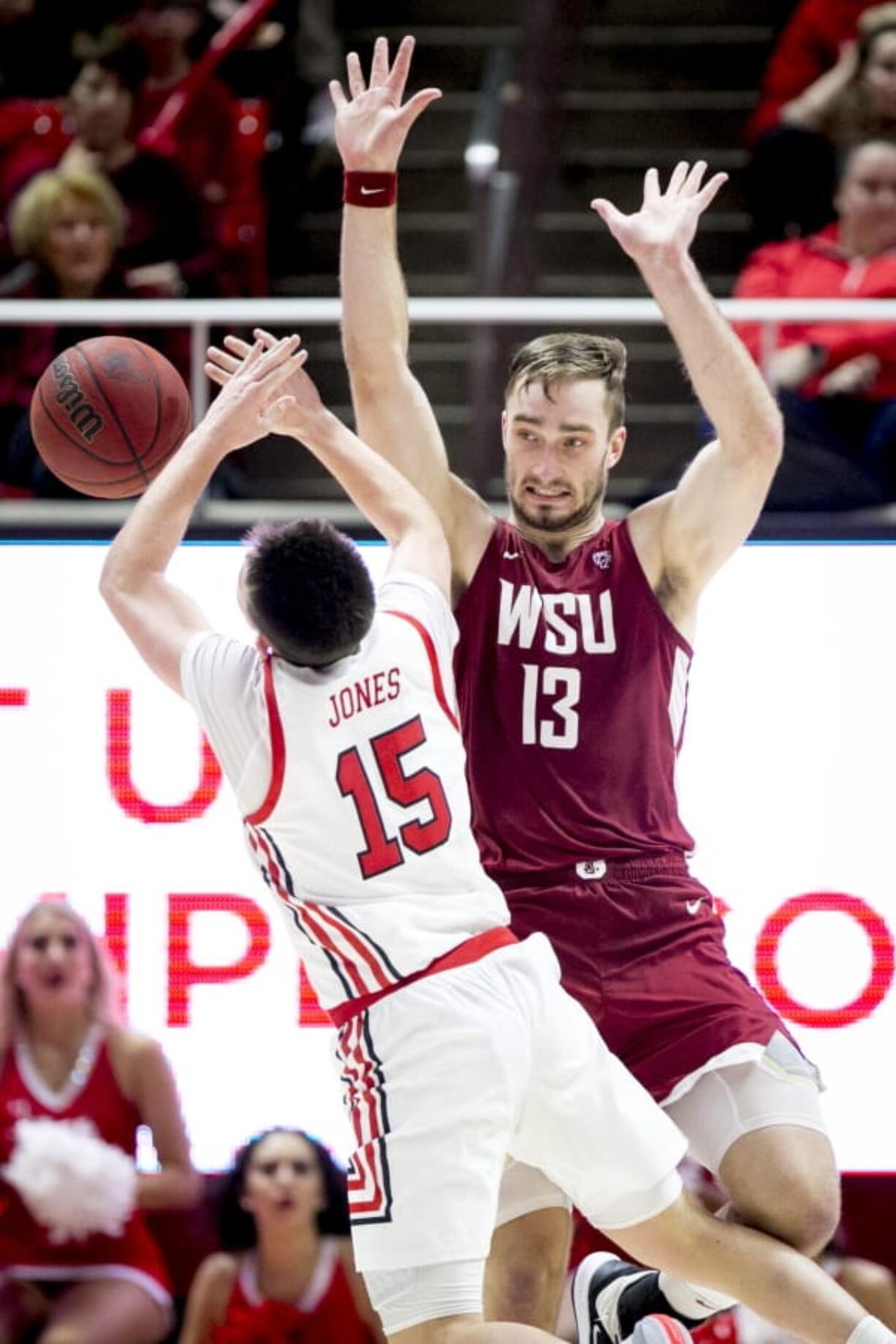 Washington State forward Jeff Pollard (13) fouls Utah guard Rylan Jones (15) who shoots in the second half during an NCAA college basketball game Saturday, Jan. 25, 2020, in Salt Lake City.