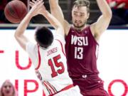 Washington State forward Jeff Pollard (13) fouls Utah guard Rylan Jones (15) who shoots in the second half during an NCAA college basketball game Saturday, Jan. 25, 2020, in Salt Lake City.