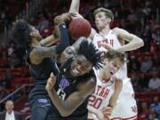 Washington&#039;s Jaden McDaniels, left, and Isaiah Stewart (33) battle against Utah&#039;s Mikael Jantunen (20)and Branden Carlson, rear, for a rebound in the first half during an NCAA college basketball game Thursday, Jan. 23, 2020, in Salt Lake City.