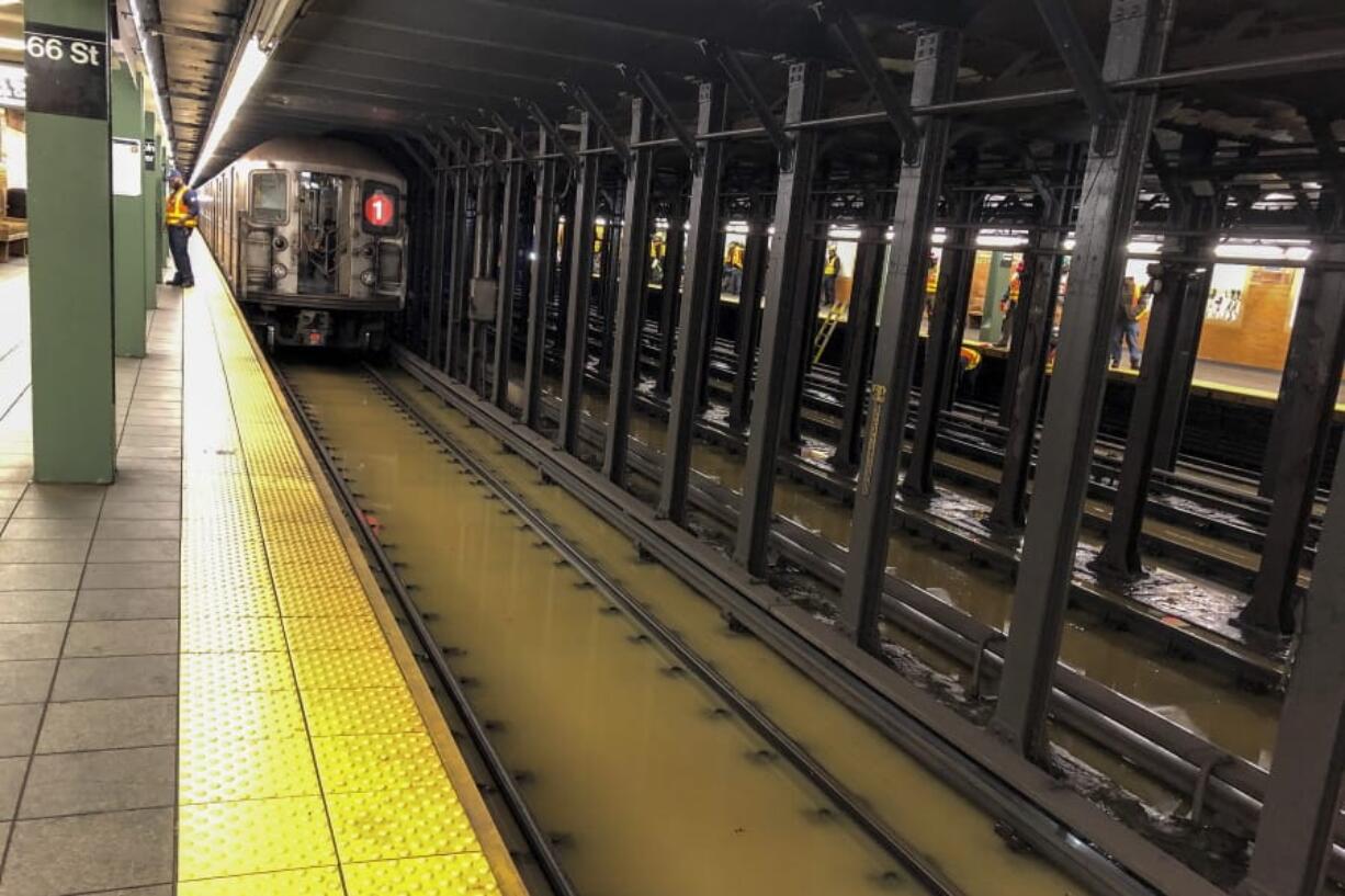 A subway train sits on flooded tracks at 66th Street, Monday, Jan. 13, 2020, in New York. A water main break flooded streets on Manhattan&#039;s Upper West Side near Lincoln Center and hampered subway service during the Monday morning rush hour. The water spread for blocks and was several inches deep in places.