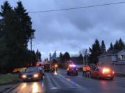 Emergency personnel investigate an early morning crash on Northeast 112th Avenue in Vancouver that killed two pedestrians.