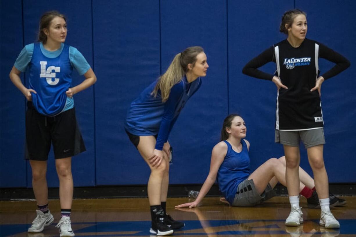 La Center&#039;s Natasha Lewis, from left, Kylee Stephens, Gianna DiEmilio, and Mia Edwards rest in between drills during a practice.