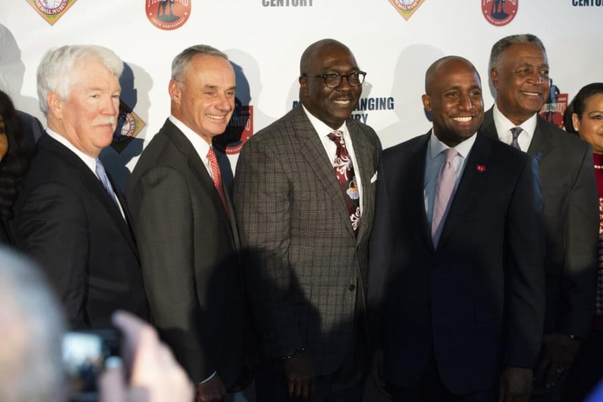 Posing for a photo during the launch ceremony for the centennial celebration of the Negro Leagues, Thursday, Feb. 13, 2020, in Kansas City, Mo., are, from left to right, Kansas City Royals owner John Sherman, Major League Baseball Commissioner Rob Manfred, Negro Leagues Baseball Museum President Bob Kendrick, Kansas City Mayor Quinton Lucas and Jackson County executive Frank White. Kansas City is home of the Negro Leagues Museum and was home of the Negro Leagues team the Kansas City Monarchs.