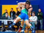 Mountain View&#039;s Va Ili launches himself at Mercer Island&#039;s Colin Farrell in their 182-pound final.