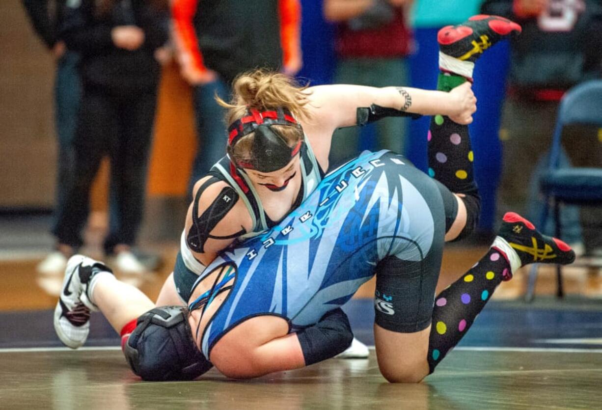 Union&#039;s Nevaeh Cassidy, top, takes down Curtis&#039; Katrina Wangen in their 155-pound championship match at the WIAA Girls Region 3 Tournament.