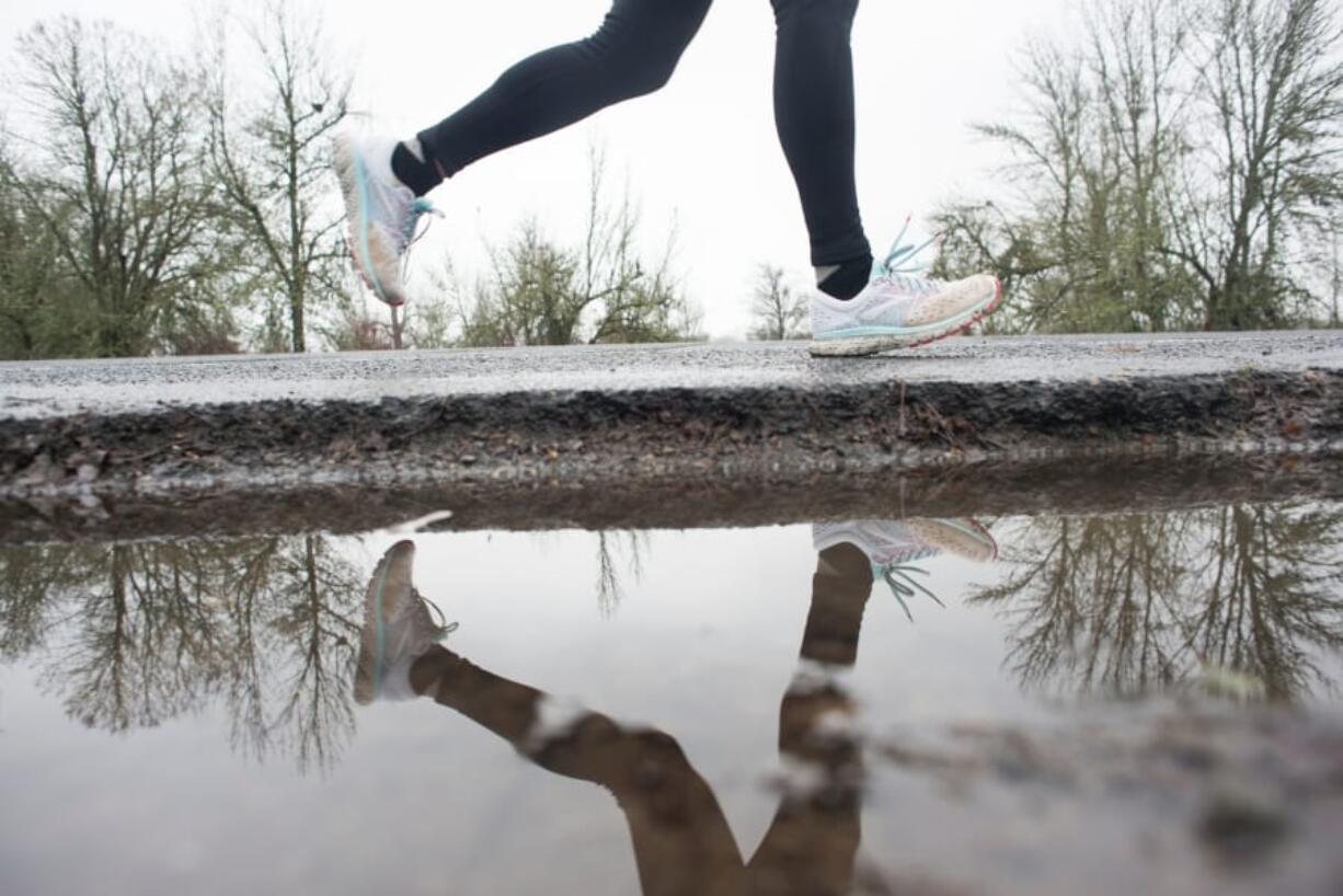 A runner races along the Erwin O. Reiger Memorial Highway during the 2019 Vancouver Lake Half Marathon.