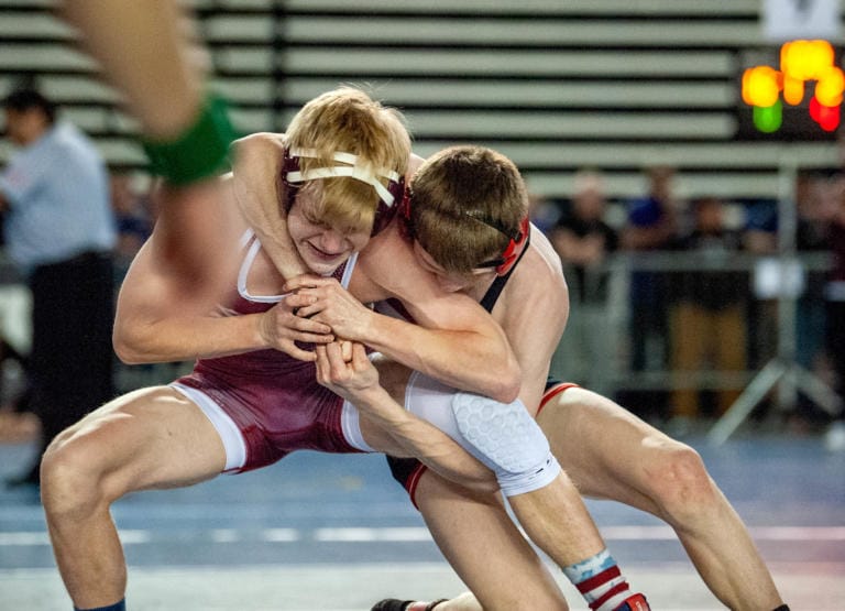 Camas sophomore Porter Craig, right, fights the hands of South Kitsap's Payton Motter in the Class 4A 106-pound quarterfinal on Friday at Mat Classic XXXII in the Tacoma Dome. Craig won by 5-0 decision.