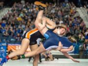 Washougal&#039;s Aleksi Donahue takes down Mount Rainier&#039;s Trisity Marshall in a 120-pound first-round match at Mat Classic XXXII Friday at the Tacoma Dome. Donahue secured the pin quickly afterward.