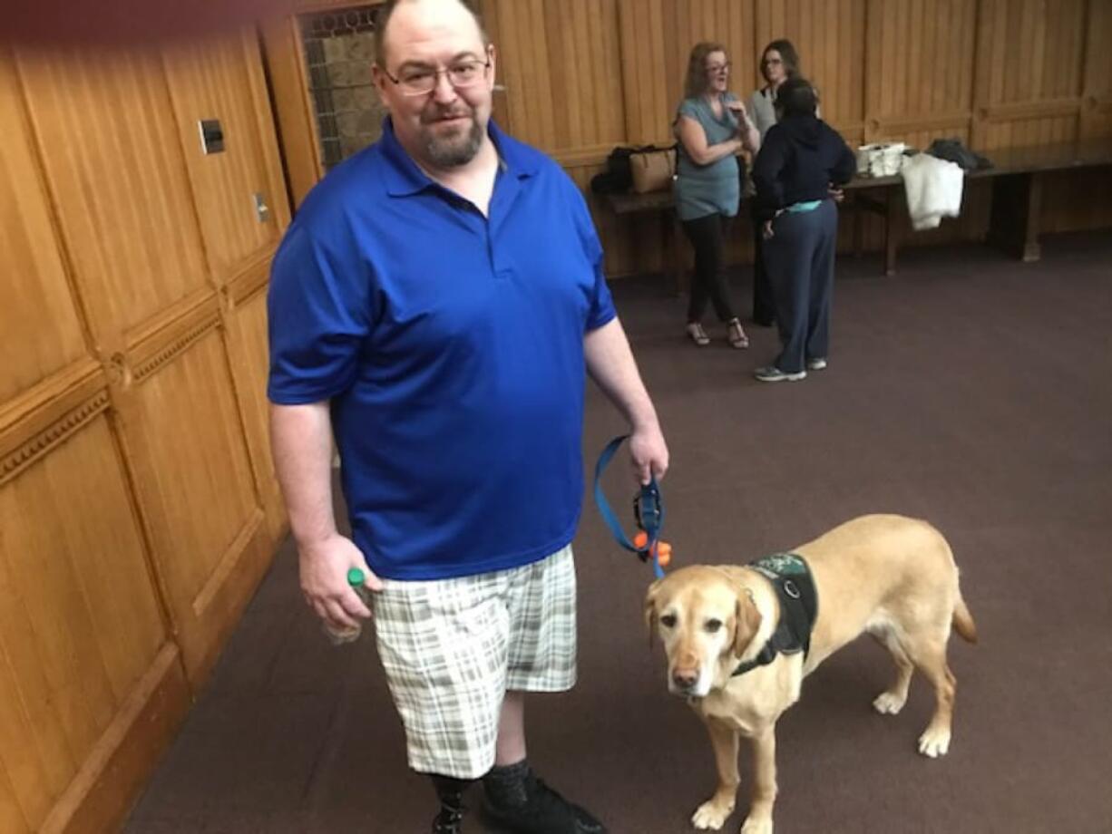 Wounded veteran Phil Bauer, 43, and Champagne make the rounds at a gathering at the Capitol to recognize the work of service dogs and trainers Lu and Dale Picard.