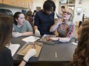 Kamryn Martin, 14, from left, Gracy Lewellen, 15, Kayalin Smith, medical science teacher Nelean Warndahl and Tina Harmon, 15, work together to dissect a fetal pig during a medical science class in April at Woodland High School.