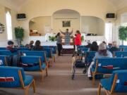 Visiting preacher Lisa Saunders, center, leads a prayer in January at the McLoughlin Heights Church of God in Vancouver. This was moments after news broke about the death of basketball star Kobe Bryant in a helicopter crash.