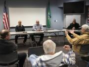 Clark County Fire District 3 Commissioners Rick Steele, center left, and Scott Anders, center right, listen to residents during an informational meeting about annexation Tuesday night at Station 31 in Brush Prairie.