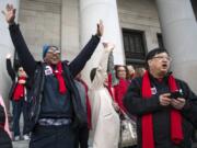 Amon Rutherford of Vancouver, left, and Gary Akizuki, right, cheer as the 17th Legislative District is called during a rally at Housing and Homelessness Advocacy Day on the Capitol steps in Olympia. Akizuki has been coming to the advocacy day since 2003 when a smaller crowd met with legislators. &quot;The things we do up here, lobbying, makes a difference,&quot; he said.